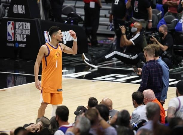 Devin Booker of the Phoenix Suns taunts the crowd against the LA Clippers during the second half in Game Six of the Western Conference Finals at...