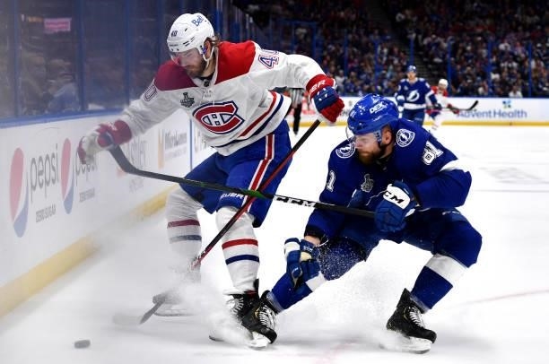 Joel Armia of the Montreal Canadiens and Erik Cernak of the Tampa Bay Lightning battle for the puck during the second period of Game Two of the 2021...