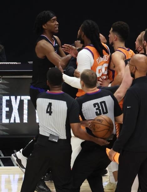 Jae Crowder of the Phoenix Suns and Terance Mann of the LA Clippers are held apart during the second half in Game Six of the Western Conference...