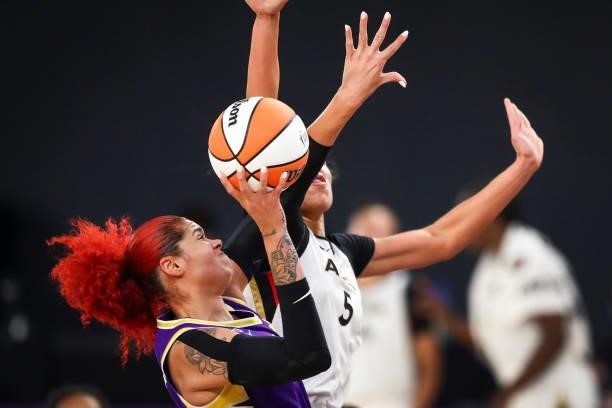 Center Amanda Zahui B of the Los Angeles Sparks drives to the basket defended by forward Dearica Hamby of the Las Vegas Aces in the second half at...