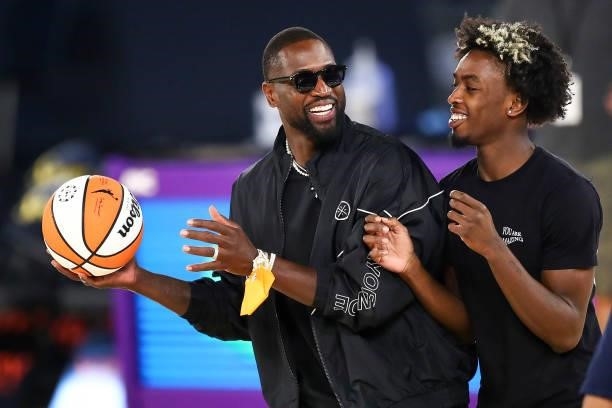 Former NBA player Dwyane Wade and his son Zaire Wade spend time on the court after the game between the Los Angeles Sparks and the Las Vegas Aces at...