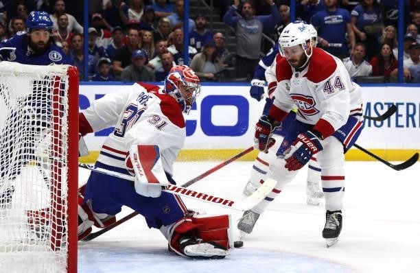 Goaltender Carey Price of the Montreal Canadiens makes a save next to teammate Joel Edmundson against the Tampa Bay Lightning during the second...