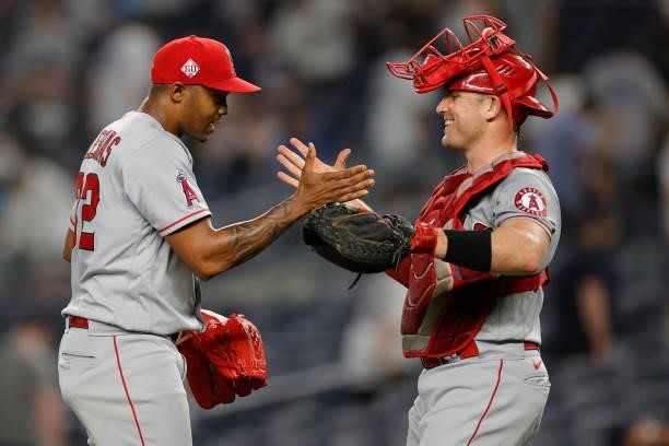Raisel Iglesias high-fives Max Stassi of the Los Angeles Angels during the ninth inning against the New York Yankees at Yankee Stadium on June 30,...