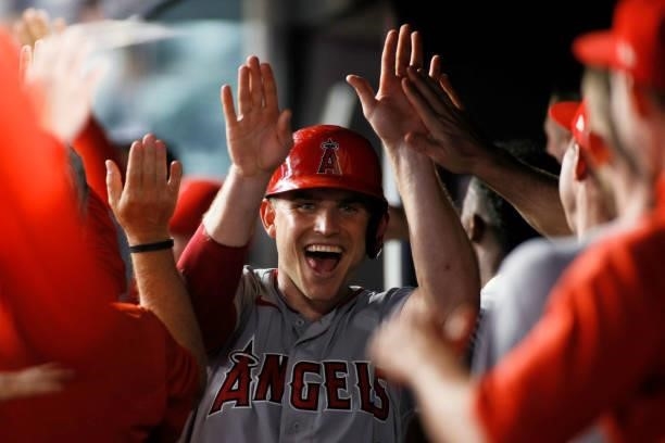 Max Stassi of the Los Angeles Angels high-fives teammates after scoring on a grand slam hit by Jared Walsh during the ninth inning against the New...