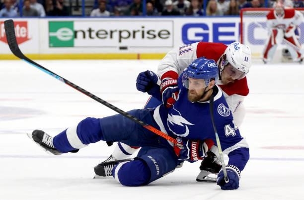 Brendan Gallagher of the Montreal Canadiens takes down Jan Rutta of the Tampa Bay Lightning during the second period of Game Two of the 2021 Stanley...