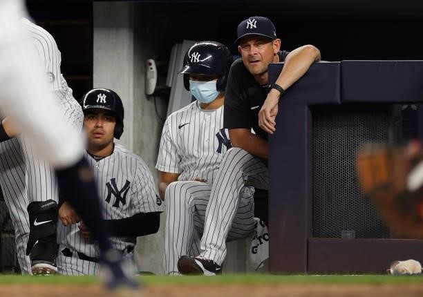Manager Aaron Boone of the New York Yankees looks on from the dugout during the third inning against the Los Angeles Angels at Yankee Stadium on June...