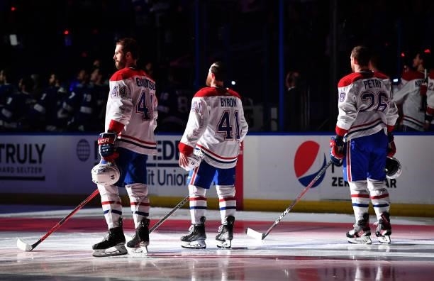 Joel Edmundson, Paul Byron and Jeff Petry of the Montreal Canadiens line up during pregame for Game Two of the 2021 Stanley Cup Final against the...