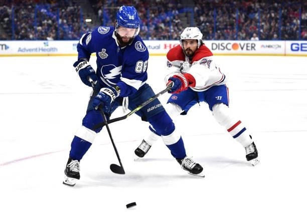 Nikita Kucherov of the Tampa Bay Lightning controls the puck away from Phillip Danault of the Montreal Canadiens during the first period of Game Two...