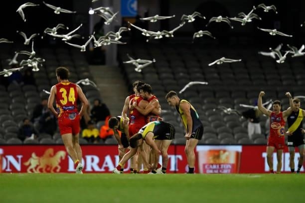 Gold Coast Suns players celebrate on the final siren during the round 16 AFL match between the Gold Coast Suns and the Richmond Tigers at Marvel...