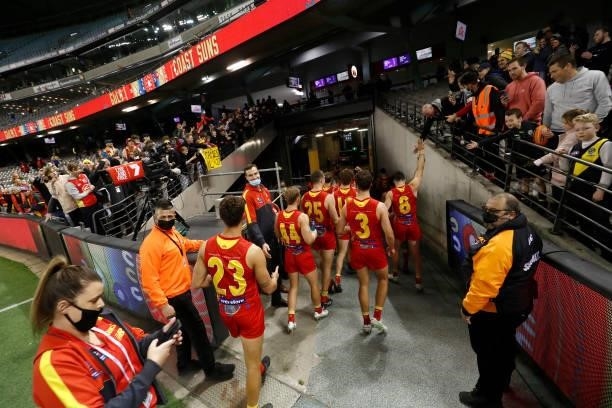 Gold Coast Suns players acknowledge their fans after the round 16 AFL match between the Gold Coast Suns and the Richmond Tigers at Marvel Stadium on...