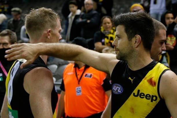Trent Cotchin pats team mate Jack Riewoldt of the Tigers on the back after the round 16 AFL match between the Gold Coast Suns and the Richmond Tigers...