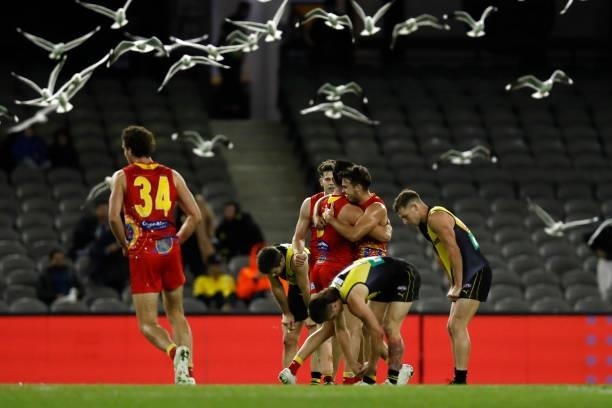 Gold Coast Suns players celebrate on the final siren during the round 16 AFL match between the Gold Coast Suns and the Richmond Tigers at Marvel...