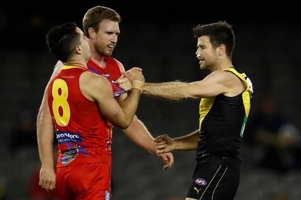 Trent Cotchin of the Tigers wrestles with Brayden Fiorini of the Suns during the round 16 AFL match between the Gold Coast Suns and the Richmond...
