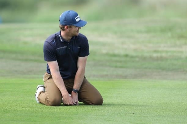 Brandon Stone of South Africa drops to his knees to inspect the fairway on the 17th hole during Day One of The Dubai Duty Free Irish Open at Mount...