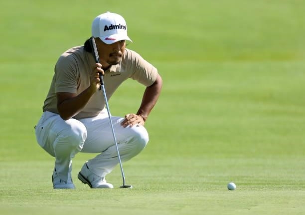 Satoshi Kodaira of Japan lines up a putt on the third green during the first round of the Rocket Mortgage Classic on July 01, 2021 at the Detroit...