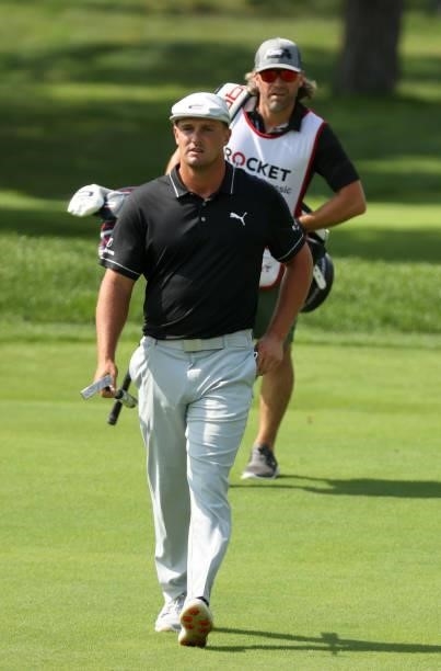 Bryson DeChambeau and caddie for the week Ben Schomin walk up the third fairway during the first round of the Rocket Mortgage Classic on July 01,...