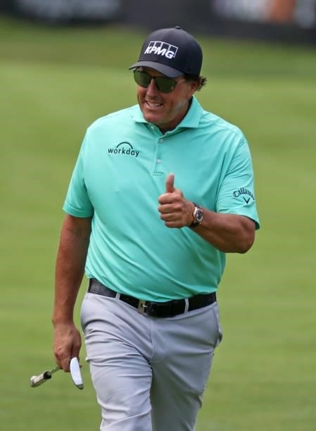Phil Mickelson reacts to the crowd as he walks to the eighth hole during the first round of the Rocket Mortgage Classic on July 01, 2021 at the...