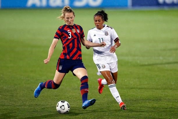 Samantha Mewis of the United States dribbles downfield past Maria Sanchez of Mexico at Rentschler Field on July 01, 2021 in East Hartford,...