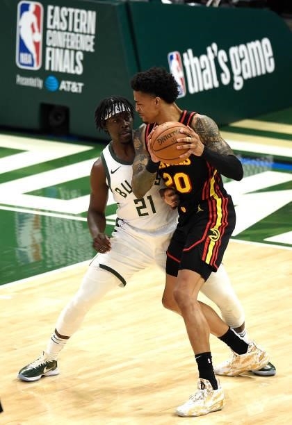 Jrue Holiday of the Milwaukee Bucks defends against John Collins of the Atlanta Hawks during the first quarter in Game Five of the Eastern Conference...