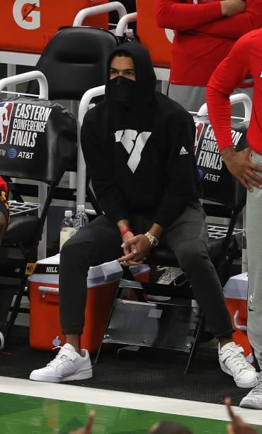 Trae Young of the Atlanta Hawks looks on from the bench against the Milwaukee Bucks in Game Five of the Eastern Conference Finals at Fiserv Forum on...