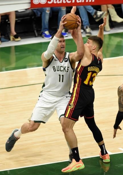 Brook Lopez of the Milwaukee Bucks drives to the basket against Bogdan Bogdanovic of the Atlanta Hawks in Game Five of the Eastern Conference Finals...