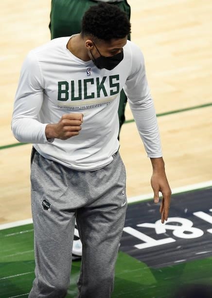 Giannis Antetokounmpo of the Milwaukee Bucks celebrates from the bench against the Atlanta Hawks during the first quarter in Game Five of the Eastern...