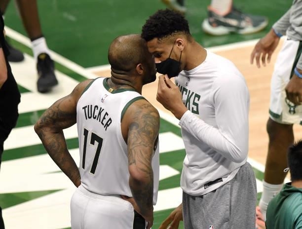 Giannis Antetokounmpo of the Milwaukee Bucks talks with P.J. Tucker during a time out during the first half in Game Five of the Eastern Conference...