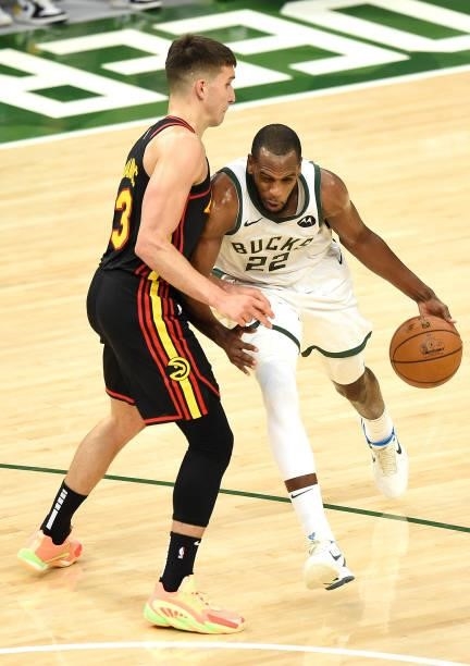 Khris Middleton of the Milwaukee Bucksdrives to the basket against Bogdan Bogdanovic of the Atlanta Hawks during the first half in Game Five of the...
