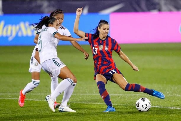 Alex Morgan of United States takes a shot against Karina Rodriguez of Mexico at Rentschler Field on July 01, 2021 in East Hartford, Connecticut.