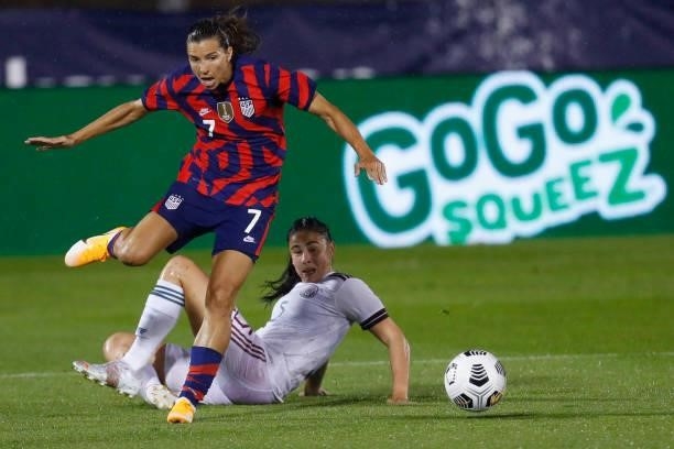 Tobin Heath of United States jumps over Jimena Lopez of Mexico at Rentschler Field on July 01, 2021 in East Hartford, Connecticut.