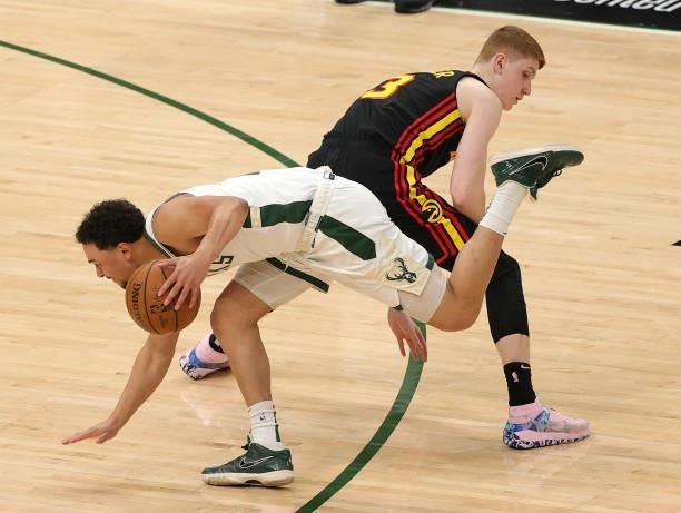 Bryn Forbes of the Milwaukee Bucks drives around Kevin Huerter of the Atlanta Hawks during the second half in Game Five of the Eastern Conference...