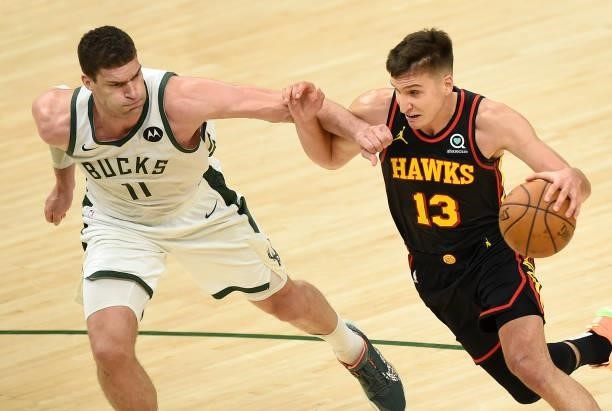 Bogdan Bogdanovic of the Atlanta Hawks drives to the basket against Brook Lopez of the Milwaukee Bucks during the second half in Game Five of the...