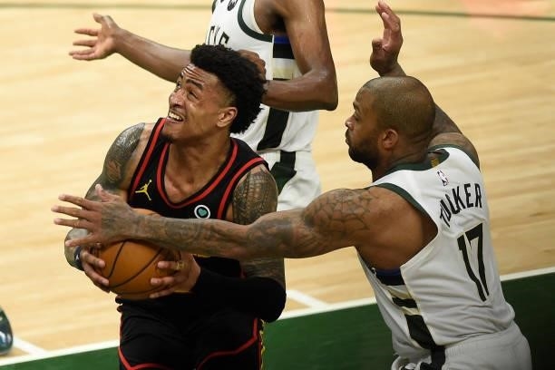 Tucker of the Milwaukee Bucks defends against John Collins of the Atlanta Hawks during the second half in Game Five of the Eastern Conference Finals...