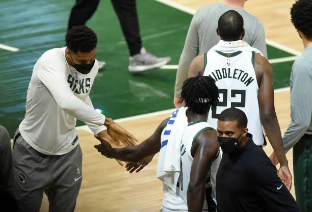 Giannis Antetokounmpo of the Milwaukee Bucks celebrates with Jrue Holiday after the team's win against the Atlanta Hawks in Game Five of the Eastern...