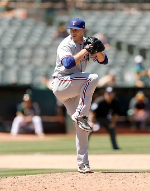 John King of the Texas Rangers pitches against the Oakland Athletics at RingCentral Coliseum on July 01, 2021 in Oakland, California.