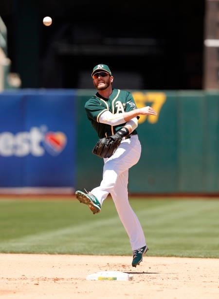 Jed Lowrie of the Oakland Athletics throws to first base against the Texas Rangers at RingCentral Coliseum on July 01, 2021 in Oakland, California.