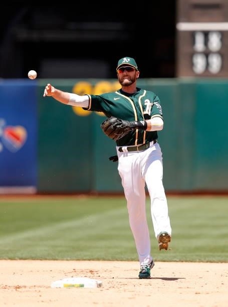 Jed Lowrie of the Oakland Athletics throws to first base against the Texas Rangers at RingCentral Coliseum on July 01, 2021 in Oakland, California.