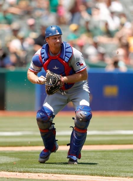 John Hicks of the Texas Rangers throws to first base against the Oakland Athletics at RingCentral Coliseum on July 01, 2021 in Oakland, California.