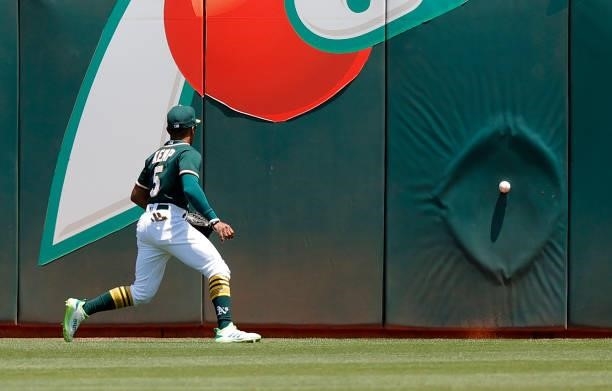 Tony Kemp of the Oakland Athletics plays the ball off the wall against the Texas Rangers at RingCentral Coliseum on July 01, 2021 in Oakland,...