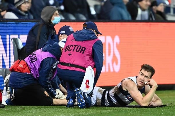 The doctors look at Jeremy Cameron of the Cats' hamstring during the round 16 AFL match between Geelong Cats and Essendon Bombers at GMHBA Stadium on...