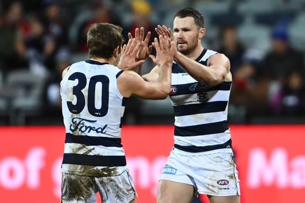 Patrick Dangerfield of the Cats is congratulated by Tom Atkins after kicking a goal during the round 16 AFL match between Geelong Cats and Essendon...