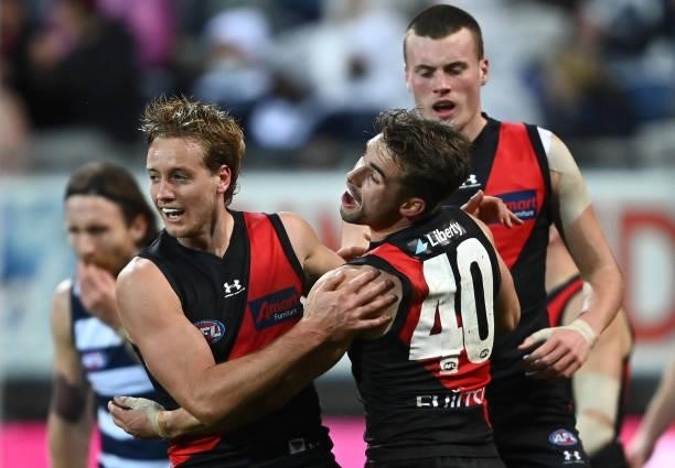 Darcy Parish of the Bombers is congratulated by Will Snelling after kicking a goal during the round 16 AFL match between Geelong Cats and Essendon...
