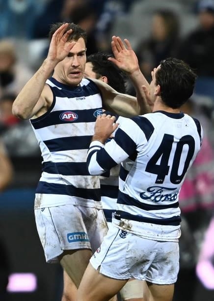Jeremy Cameron of the Cats is congratulated by Luke Dahlhaus after kicking a goal during the round 16 AFL match between Geelong Cats and Essendon...