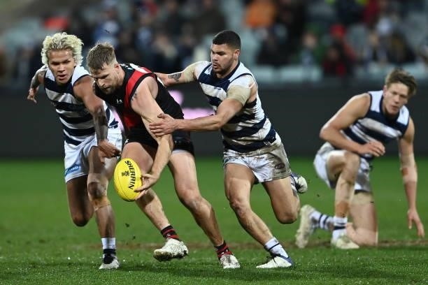 Jake Stringer of the Bombers is tackled Brandan Parfitt of the Cats during the round 16 AFL match between Geelong Cats and Essendon Bombers at GMHBA...