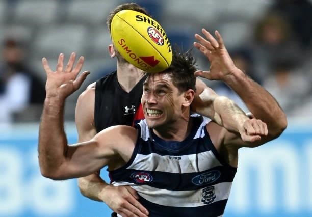 Tom Hawkins of the Cats marks infront of Jayden Laverde of the Bombers during the round 16 AFL match between Geelong Cats and Essendon Bombers at...
