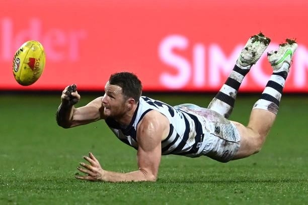 Patrick Dangerfield of the Cats handballs during the round 16 AFL match between Geelong Cats and Essendon Bombers at GMHBA Stadium on July 02, 2021...