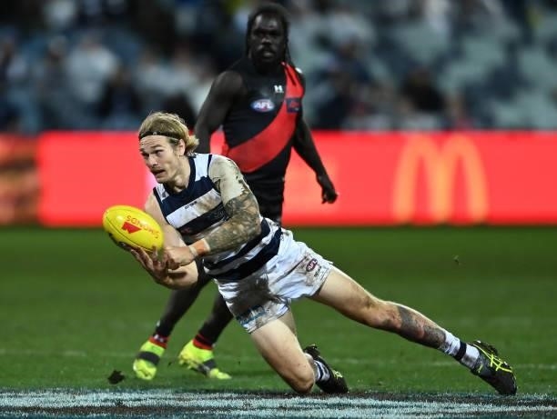 Tom Stewart of the Cats handballs during the round 16 AFL match between Geelong Cats and Essendon Bombers at GMHBA Stadium on July 02, 2021 in...