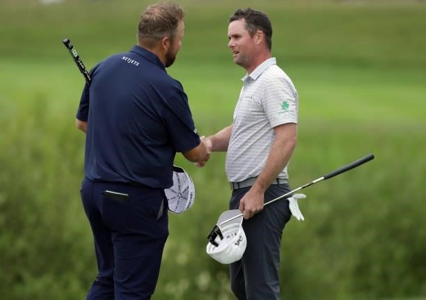 Shane Lowry of Ireland and Jonathan Caldwell of Northern Ireland shake hands on the 18th green during Day Two of The Dubai Duty Free Irish Open at...