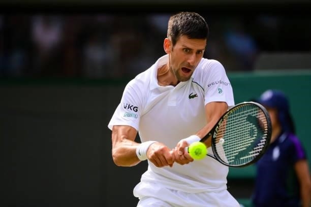 Novak Djokovic of Serbia hits a backhand against Denis Kudla of the United States in the third round of the gentlemen's singles during Day Five of...