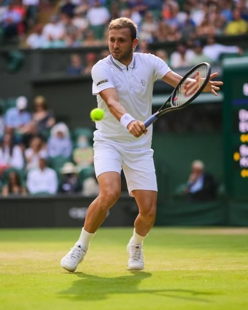 Dan Evans of Great Britain hits a backhand against Sebastian Korda of the United States in the third round of the gentlemen's singles during Day Five...